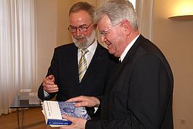 Professor Dr. Heribert Hallermann überreicht sein neuestes Buch an den Eichstätter Generalvikar Johann Limbacher
